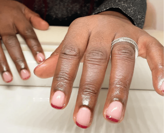 French manicure with metallic red tips.