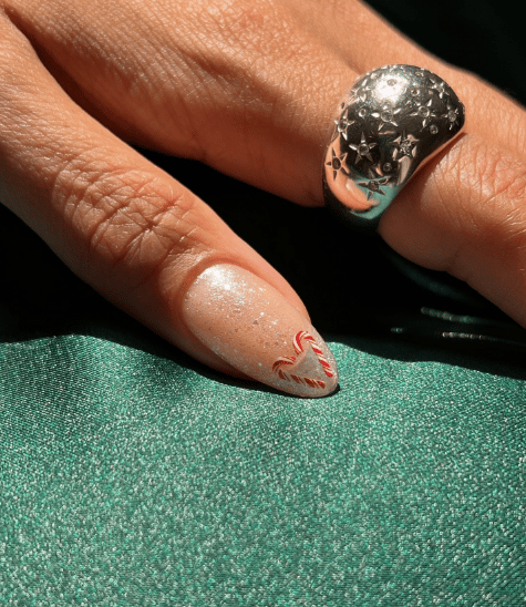 Sparky christmas nails with candy cane nail art design.