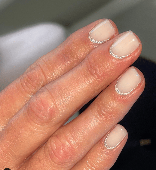 French manicure with a silver metallic touch design.