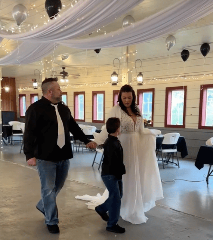 Kalina in a white dress with her husband at the empty wedding reception. No one turned up. 