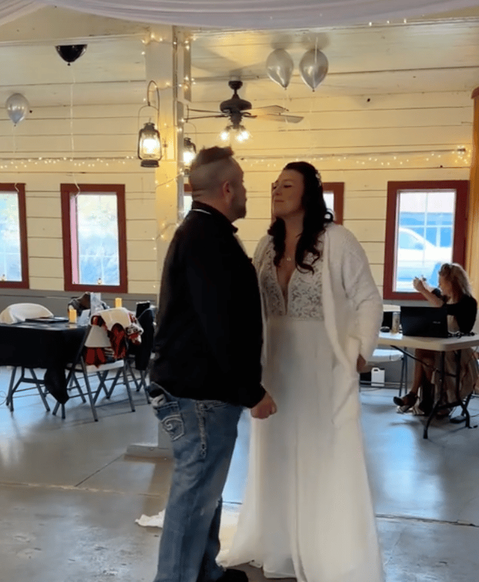 Kalina and her new husband dance in the empty wedding reception venue.