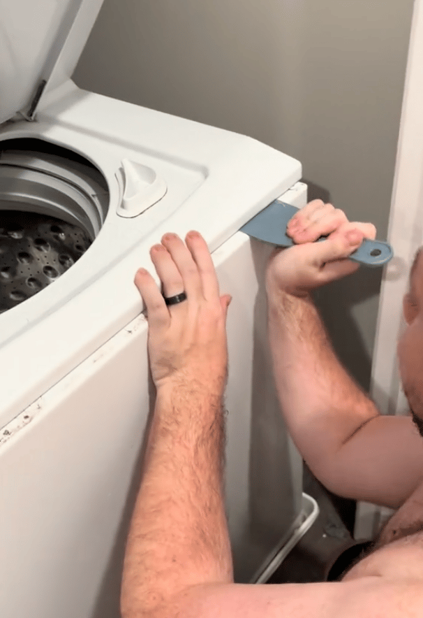 Rachel's husband opens the washing machine to find many socks.