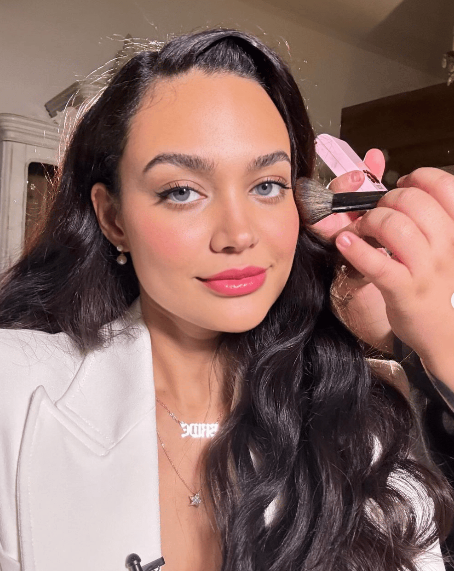 Actress Chanel Maya Banks. Woman applying makeup.