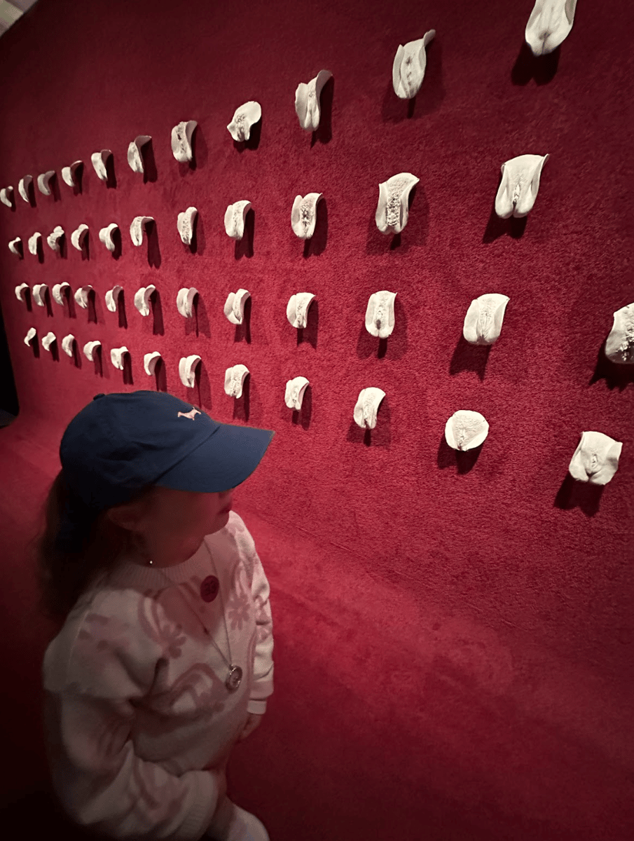 A girl visiting The Wall of Vulvas by Greg Taylor at the Museum of Old and New Art (MONA) in Hobart.