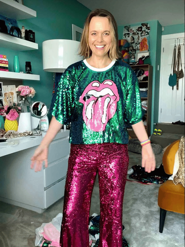 Mia Freedman wearing a green sequinned top with the Rolling Stones logo and a pair on pink sequinned trousers.
