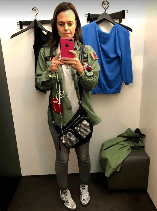 Mia Freedman in slim cut jeans standing in a changing room taking a selfie.