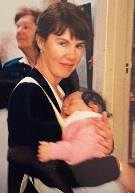 A woman carrying her five-month-old daughter.