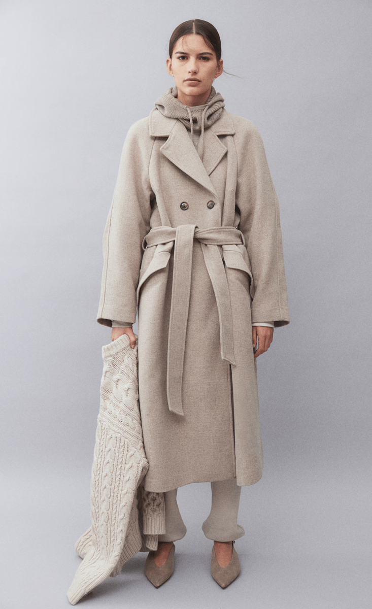 woman wearing tie belt coat in beige from H&M