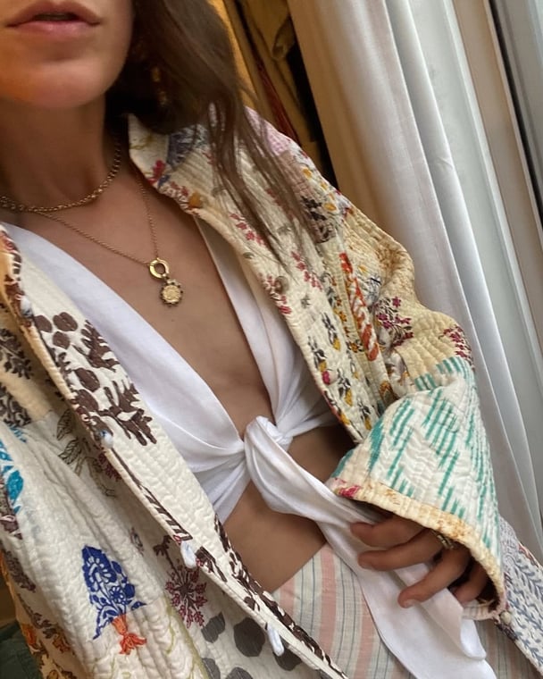 Writer wears printed embroidered jacket.