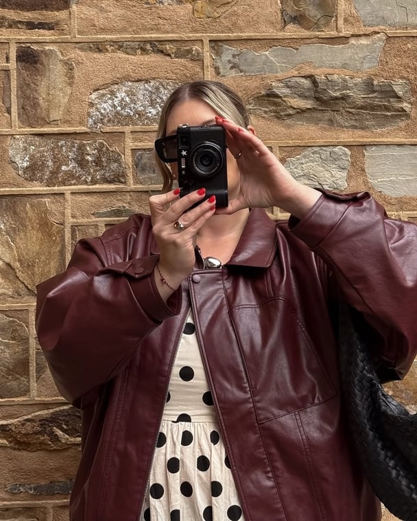 woman wearing bomber leather jacket berry
