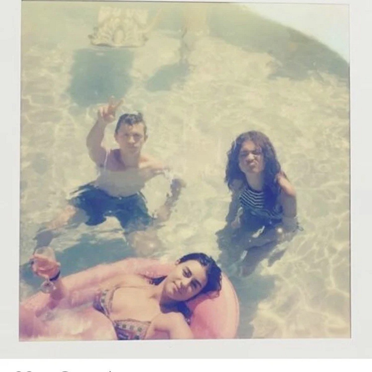 Tom Holland and Zendaya in a pool. 