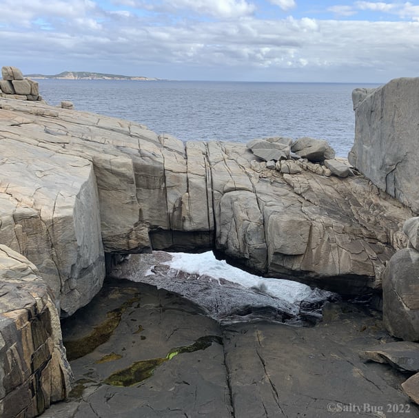 The natural bridge made of rock over the ocean.