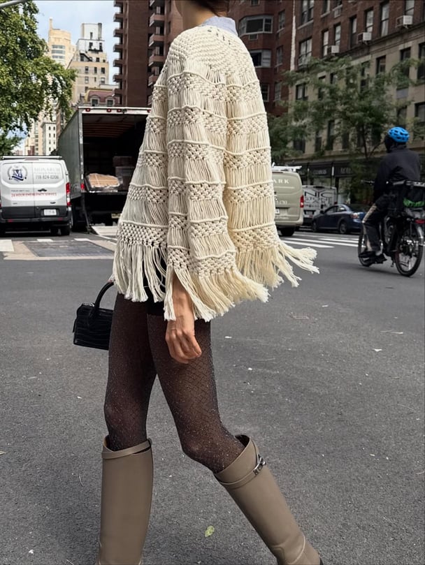 Leandra Cohen wears calf-length boots with tights in New York