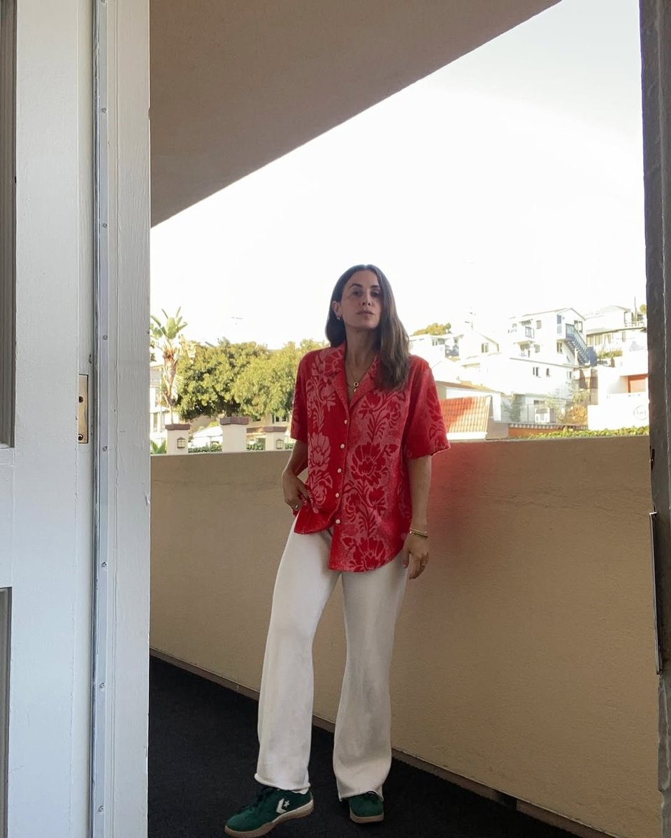 Wearing white knitted pants and a red cabana shirt.