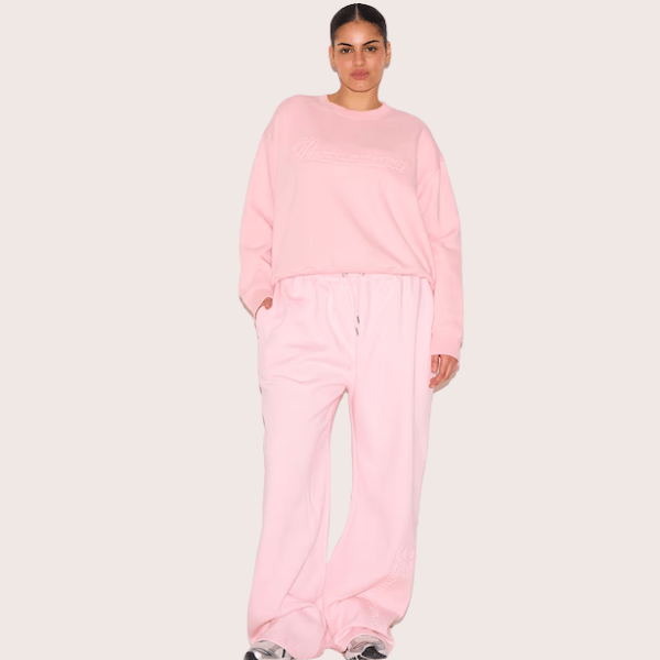 woman wearing sweatshirt and pants in pink from Pretty Little Thing