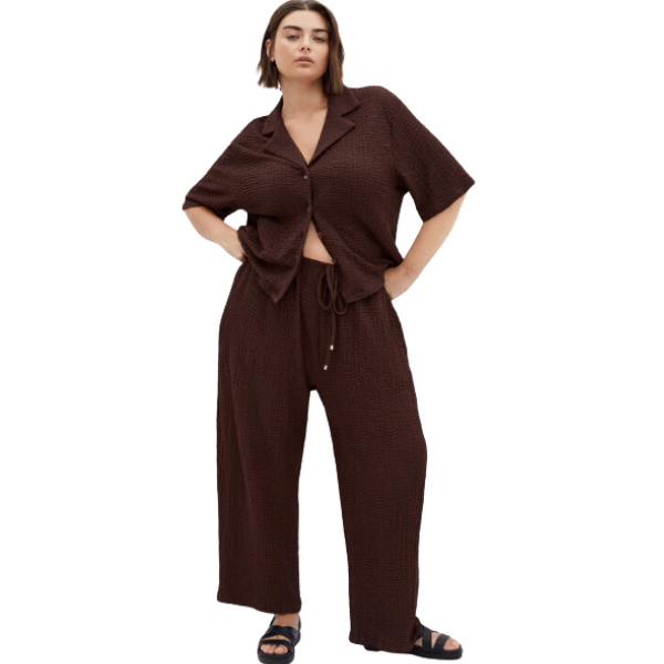 woman wearing textured crinkle top and track pants in brown from city chic