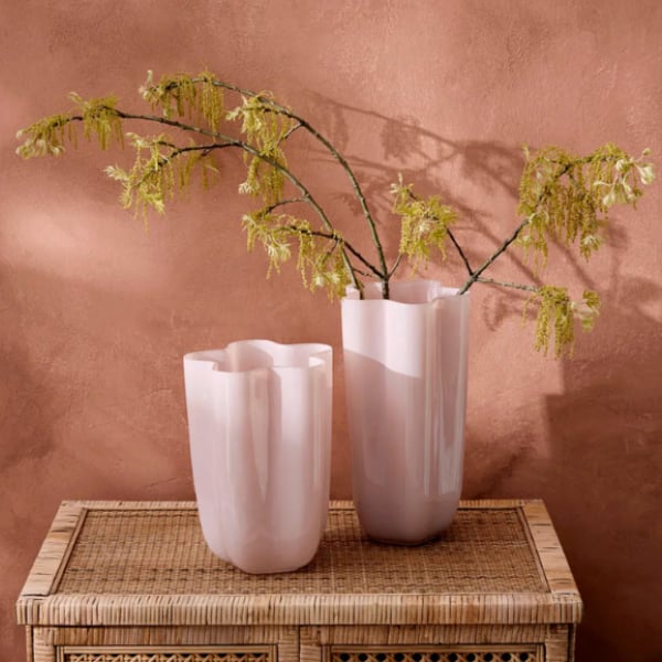 Glass vase in milky gloss finish and flowing scalloped form.