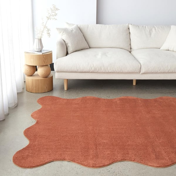 Plain and textured rug in terracotta