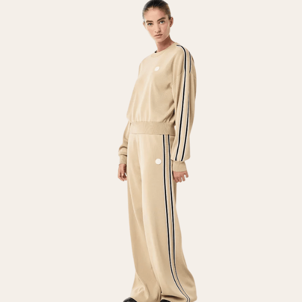 woman wearing knit top and pants in tan from P.E Nation