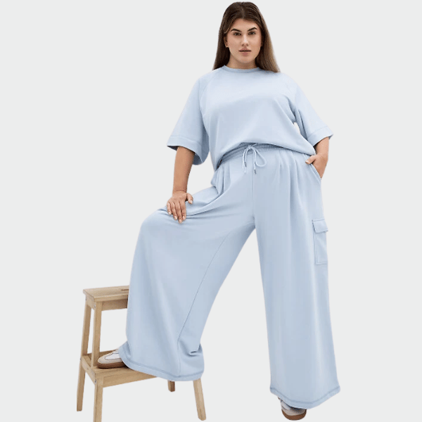 woman wearing sweat top and track pants in powder blue from city chic
