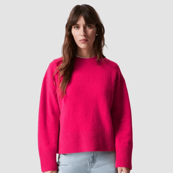 woman wearing bright pink knit jumper from & Other Stories