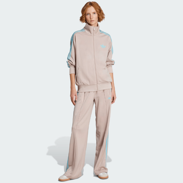 woman wearing track top and pants from Adidas