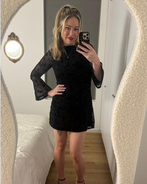 Alice taking a photo in the mirror.