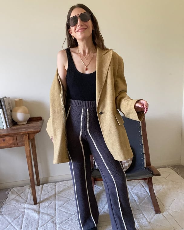 Oversized jacket and knit pants outfit.