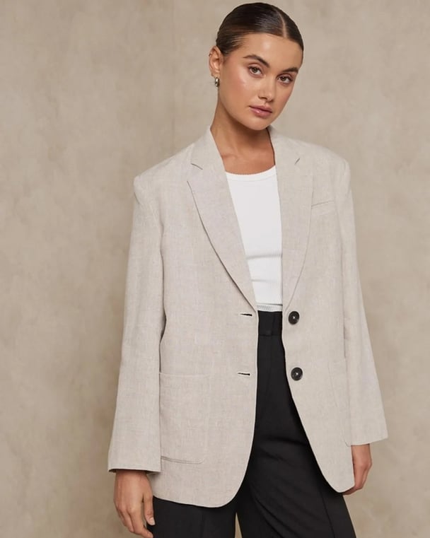 photo of a woman wearing an aot coloured linen blazer 