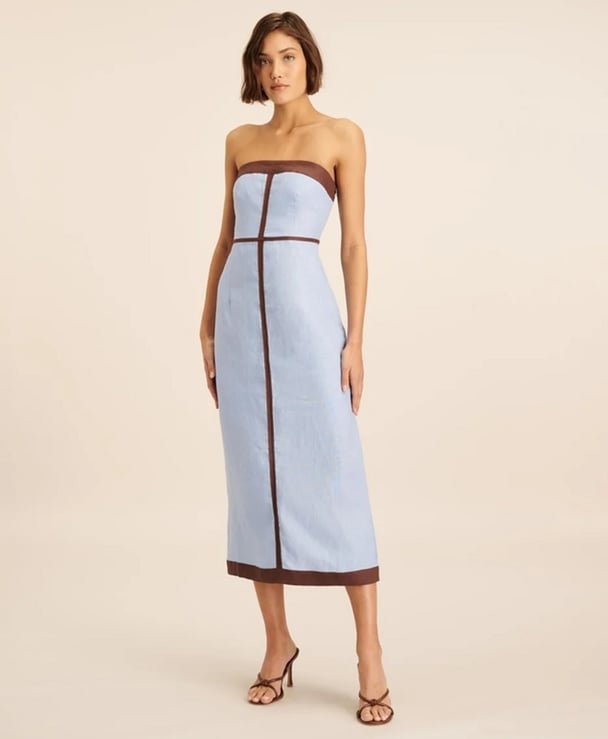 woman wearing a strapless pale blue dress with chocolate trim Aere Linen Contrast Strapless Dress
