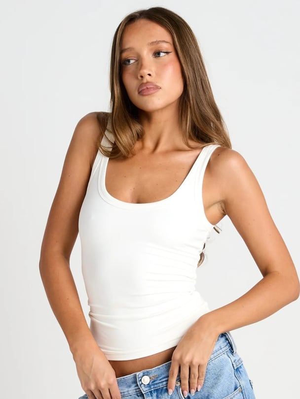 Model wears white AFM tank.