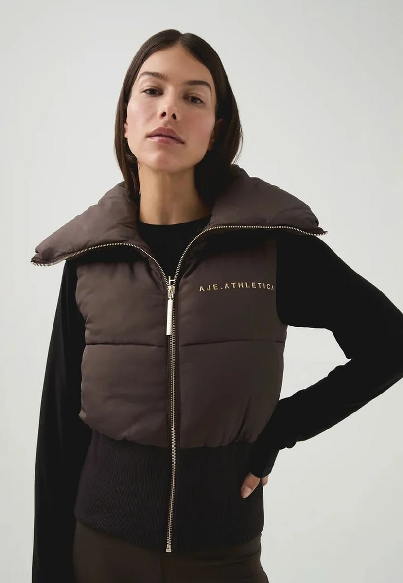 woman wearing chocoloate coloured vest from Aje
