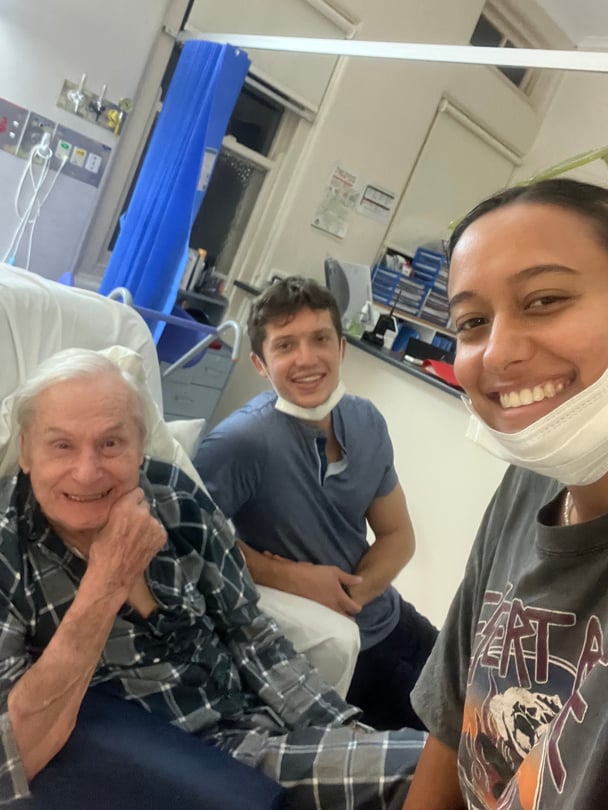 Alisa, her dad and her partner smiling in hospital.