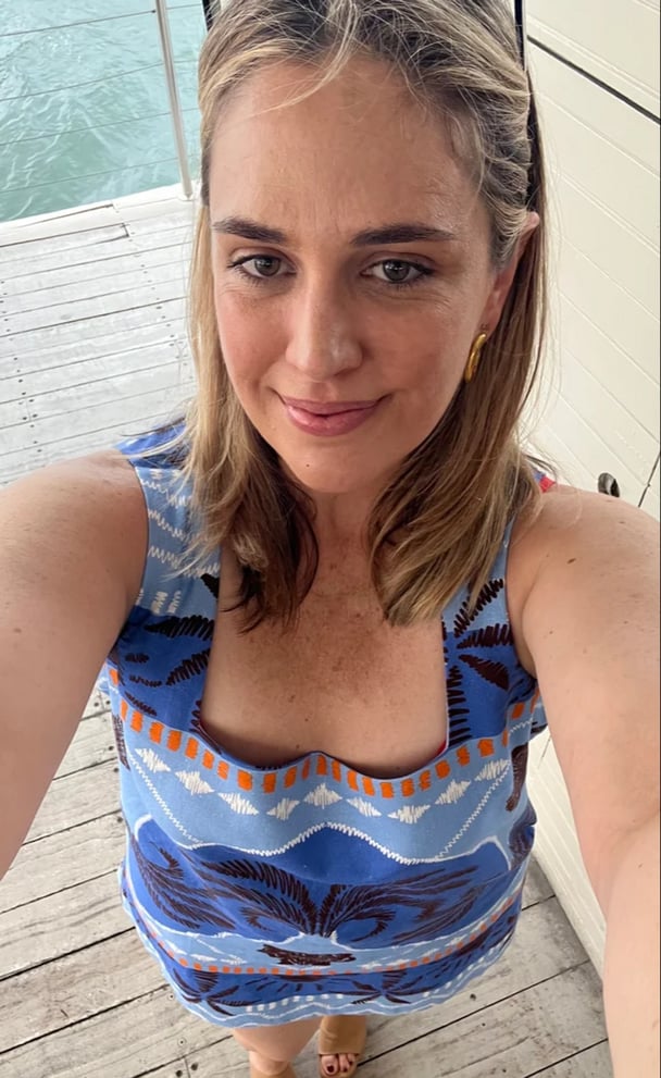 woman wearing blue dress selfie