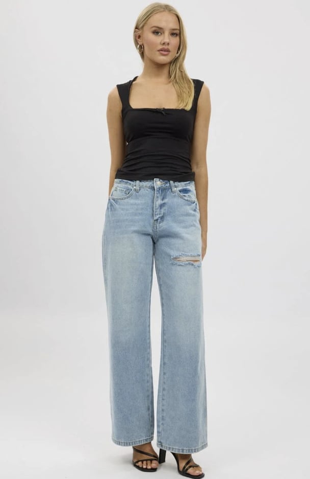 womanwearing distressed jeans from Ally