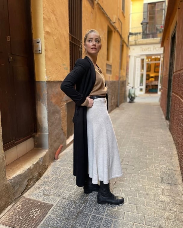 Aquaman actress Amber Heard wearing a maxi skirt, black boots and cardigan in Madrid, where she currently lives.
