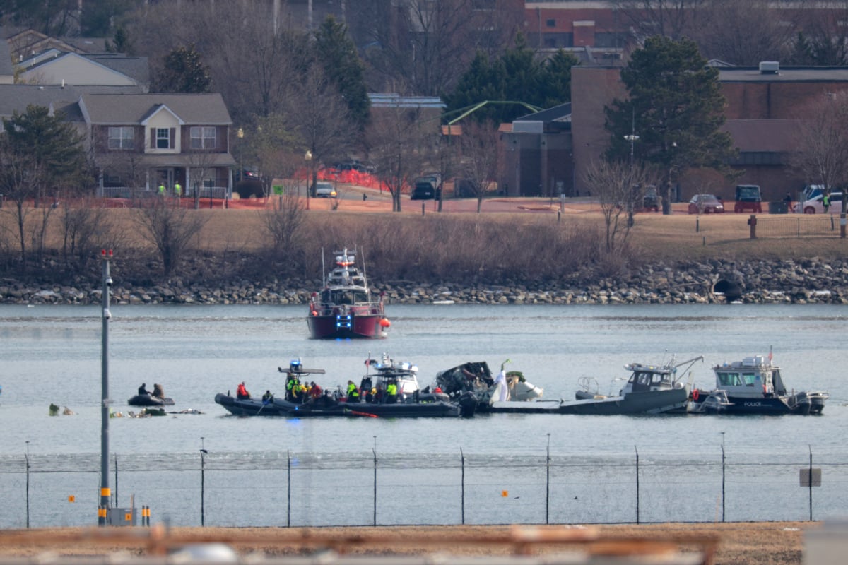 Emergency response units search the crash site of the American Airlines plane on the Potomac River after the plane crashed on approach to Reagan National Airport on January 30, 2025.