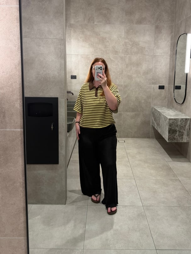 Amy wears a cropped tee with her pants. 