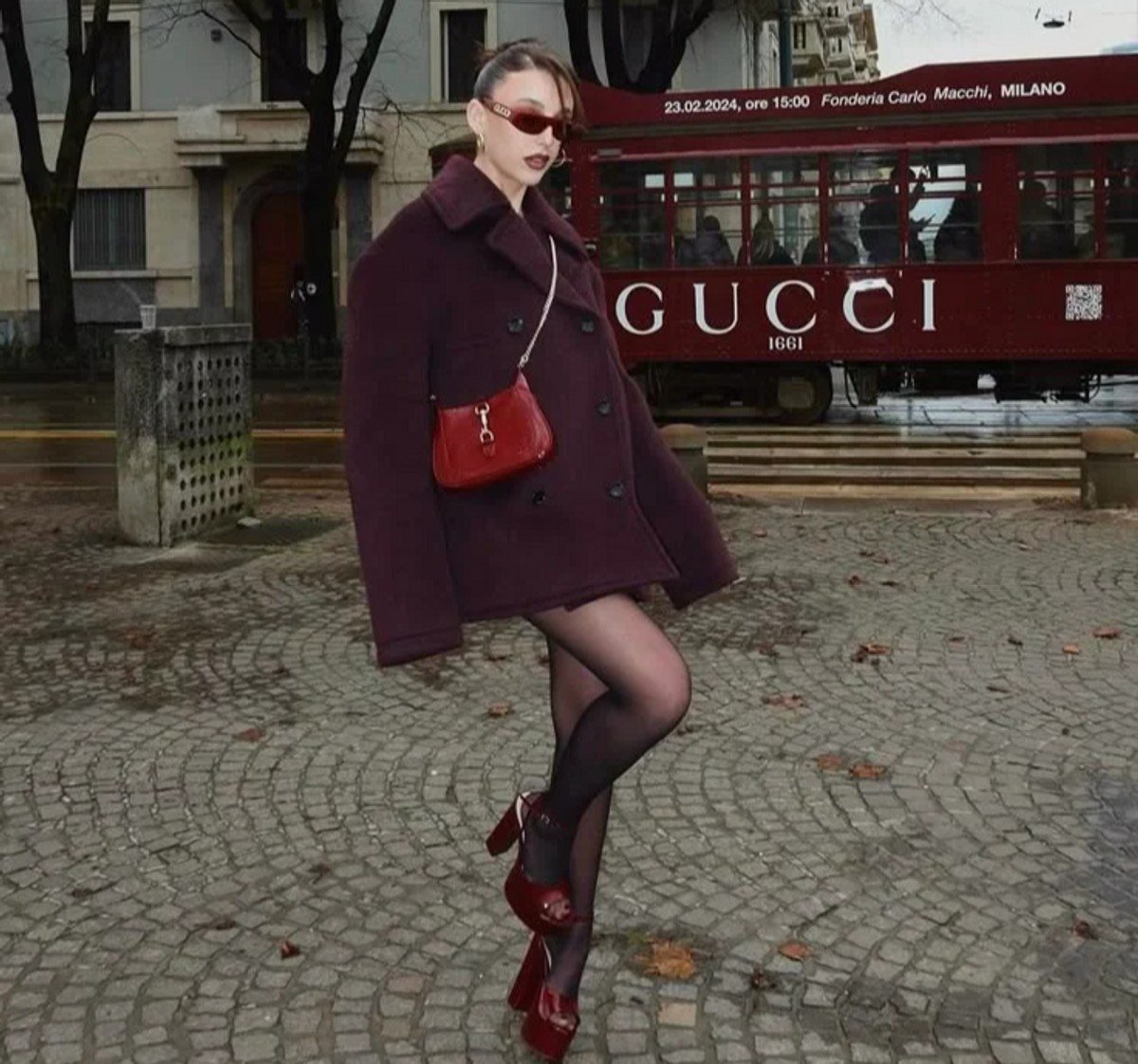 woman wearing sheer black tights with Burgendy shoes and coat 