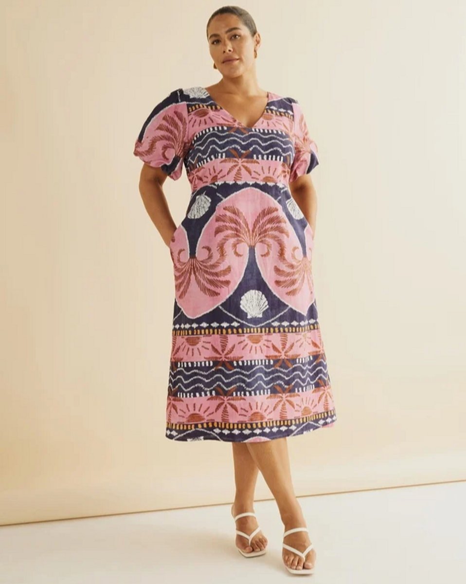 woman wearing midi dress in pink palm and navy