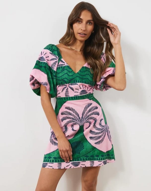 woman wearing a linen dress in pink and green Atmos&Here Maldives Linen Blend Mini Dress