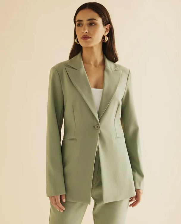 woman wearing a sage green suit 