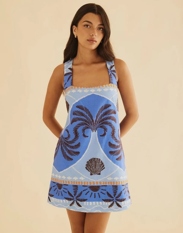 woman wearing a mini shift dress in blue and orange with shells and tree print Atmos&Here Palmer Linen Blend Shift Dress