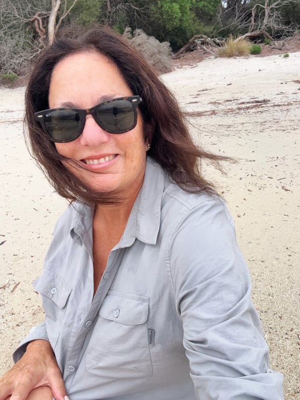 Leonie enjoying a quiet moment on a Flinders Island beach.