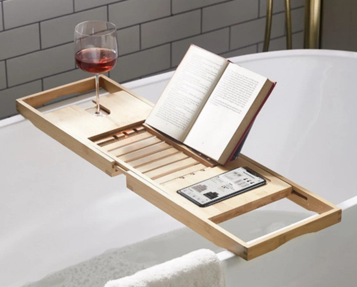 A Bamboo Bath Caddy holding a phone, book and wine glass