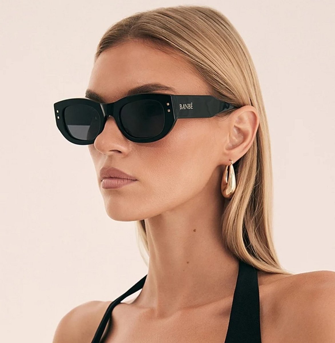 woman wearing large black glasses