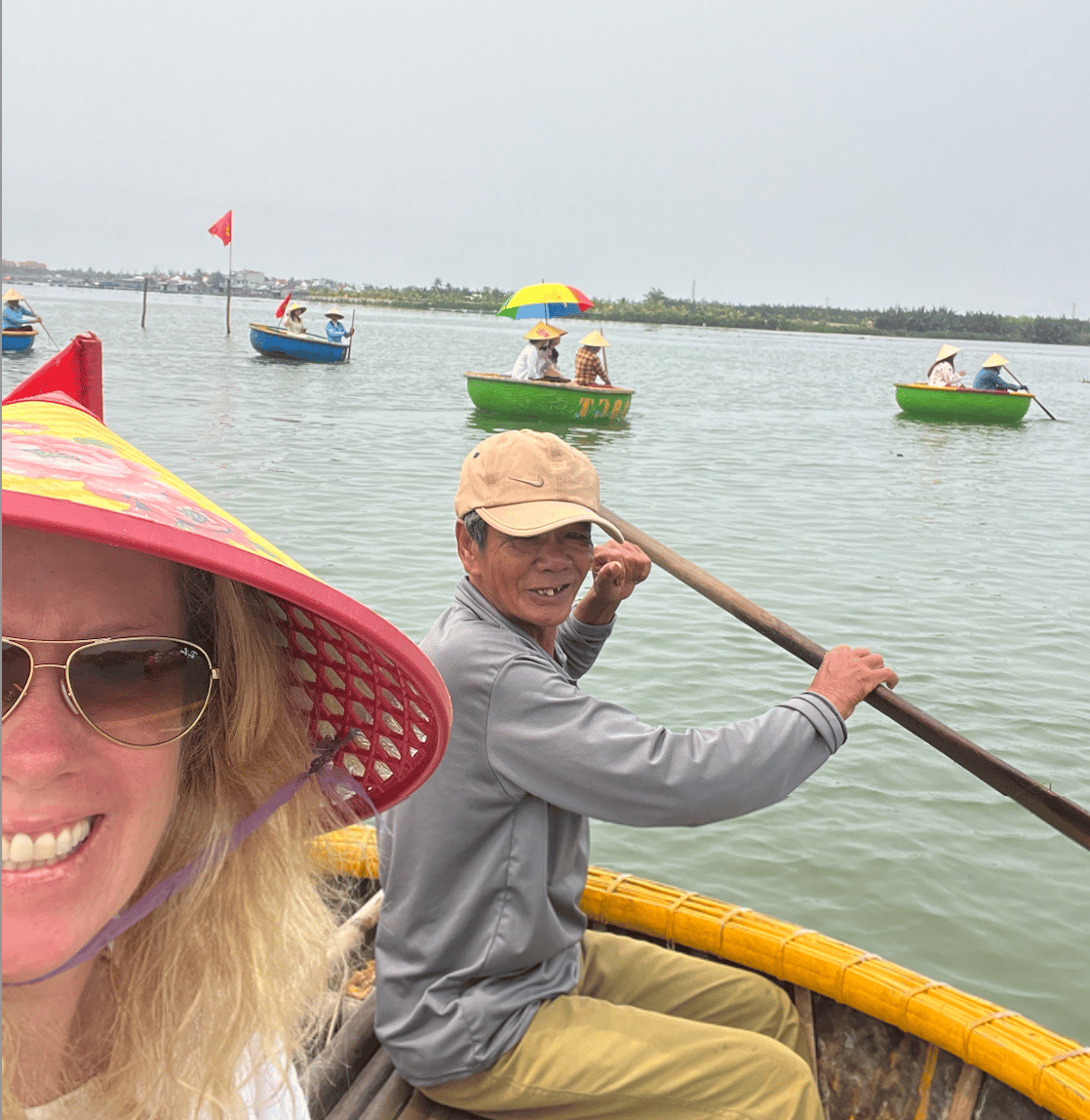 A woman and man row in a basket boat.