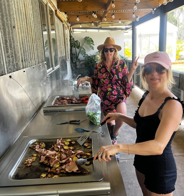 photo of women cooking on communal barbeques