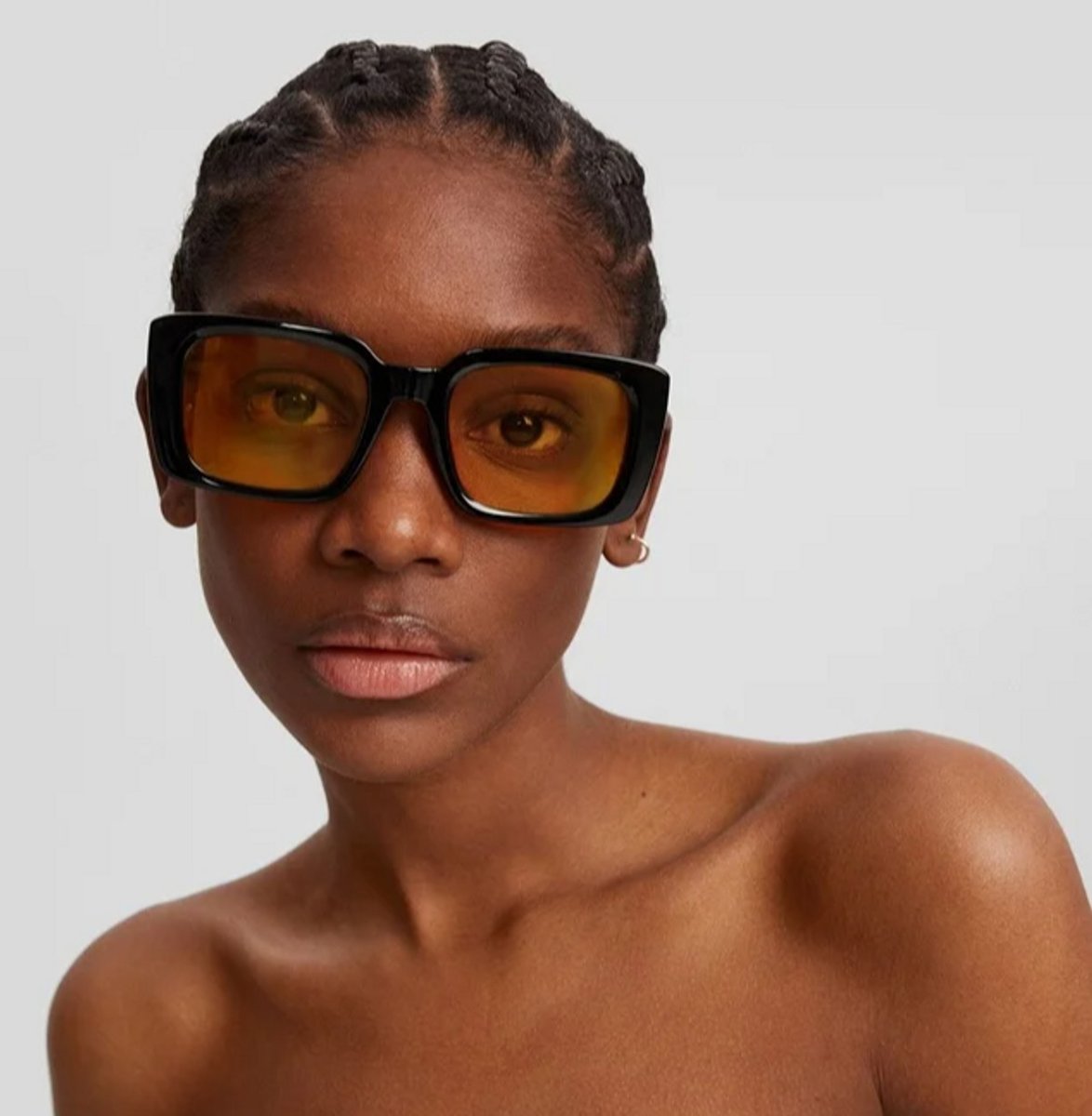 woman wearing oversize yellow tinted glasses