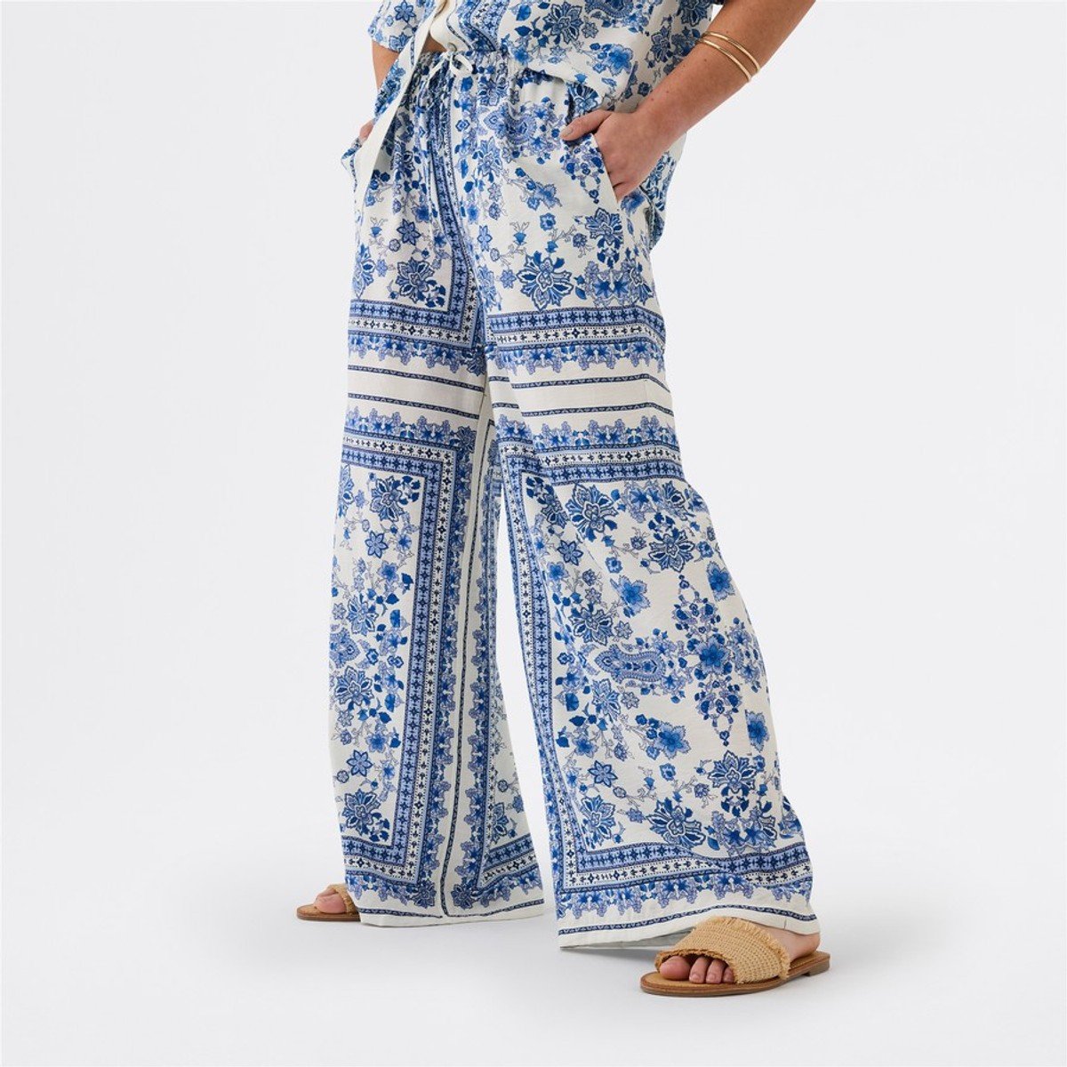 woman wearing blue and white set pants from Big W 